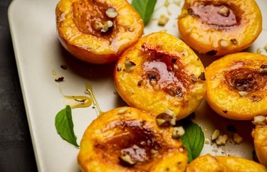 halved peaches on a white plate