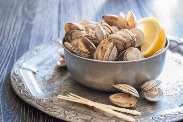 A bowl of vitamin B12-rich steamed clams on table.
