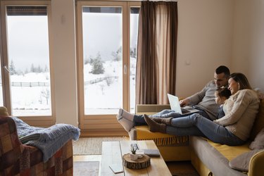 a family relaxing on the sofa at home during winter