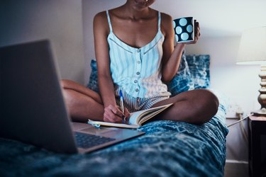A woman sipping senna tea before bed to help her poop in the morning