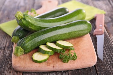 vitamin A-rich raw zucchini on wooden cutting board
