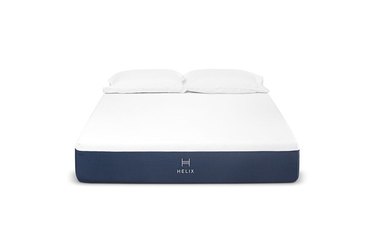 A white and navy blue mattress on a white background