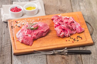 Raw meat on wooden cutting board